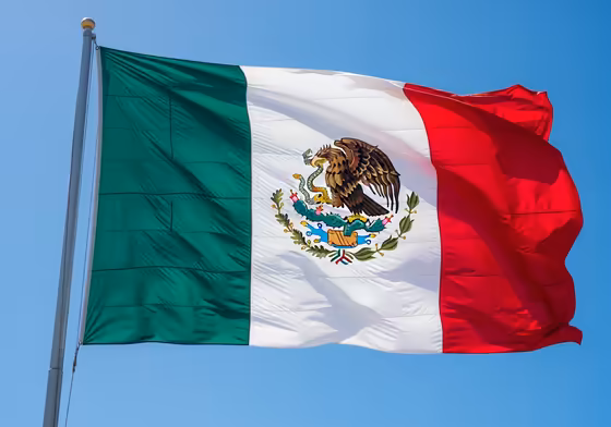 The modern flag of Mexico, showing the central emblem of an eagle on a cactus eating a snake, which originates from Aztec legend.