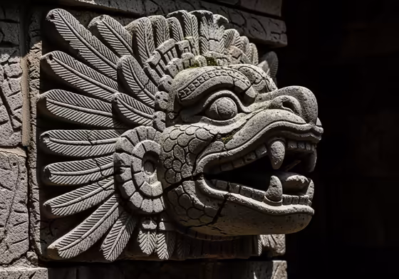 A stone carving of the Feathered Serpent god, Quetzalcoatl, from a Mesoamerican temple.